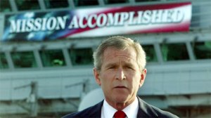 President George W. Bush, under the “Mission Accomplished” banner during the ceremony of breaking ground for the Presidential Library. (Image source: thepoliticalzealot.com)